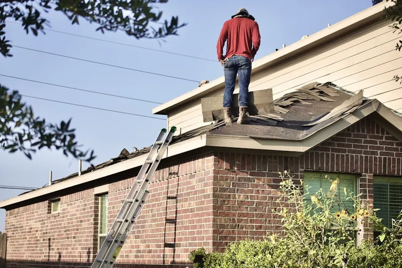 Professional roofer working on a residential roof in Rose Garden